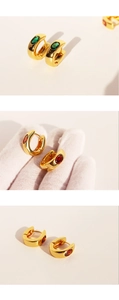 Detailed comparison showing size and textures of gold U-shaped earrings with gems