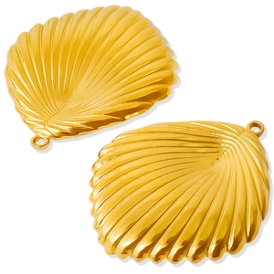 Macro detail of two golden stainless steel shell charms with textured metal finish