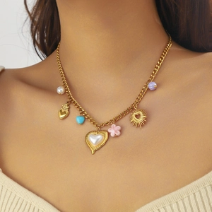 Gold-plated stainless steel necklace with pearl heart and colorful charms on model