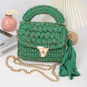 Detail of green handmade crochet crossbody bag with gold metallic thread and buckle