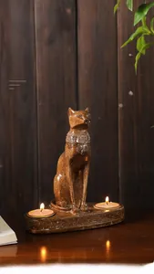 Detail of vintage bronze Egyptian cat candle holder with engraved runes and relief base