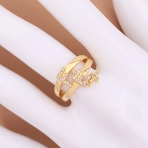 Detail view of a gold double-row pin ring featuring ELLE zircon letters and cross pendant