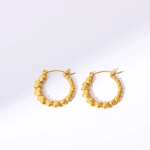 Detail of gold heart hoop earrings featuring connected 3D hearts on white background