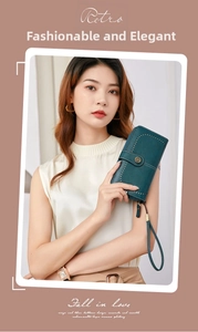 Detail of teal oil wax leather wallet with retro metal button and wrist strap