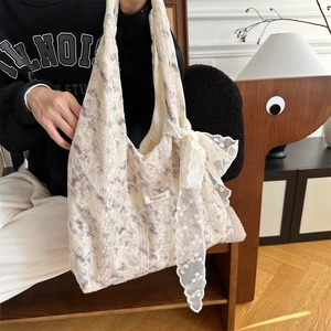Detail of floral lace tote bag with large purple floral pattern and aesthetic bow decoration