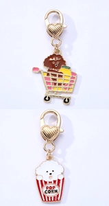 Detail of colorful dog enamel charms with heart spring clasps and popcorn designs