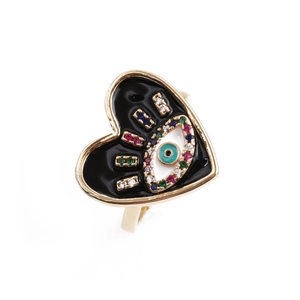 Detail of gold heart ring with black enamel, evil eye symbol and colorful zircon stones