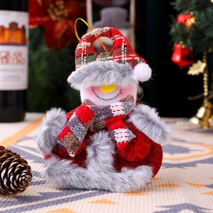 Plush snowman Christmas ornament featuring a festive knit hat and soft faux fur detail