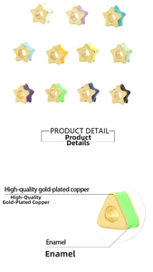 Detailed macro of colorful enamel gold-plated star and triangle beads for jewelry making