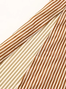 Macro shot of striped tencel shirt dress fabric showing stitching and texture