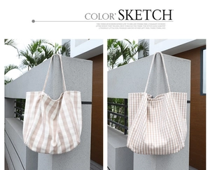 Detail of canvas tote bags with striped and plaid patterns in beige and white
