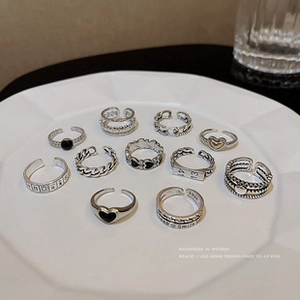 Macro detail of vintage S925 silver ring set with engraved heart and chain patterns