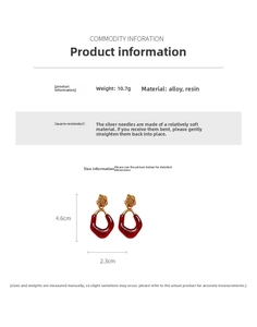 Macro shot of oval burgundy resin earrings showing height 4.6cm and width 2.3cm