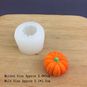 Detail view of 3D pumpkin silicone mold with finished orange resin model on wood board