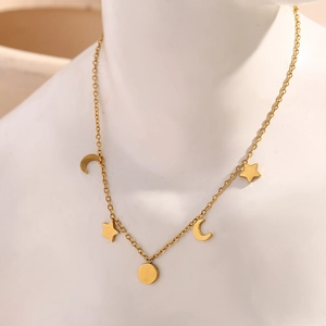 18K gold plated stainless steel bracelet featuring star and moon charms on model