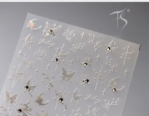Macro shot of silver laser nail stickers featuring holographic butterflies and crescent moons