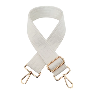 Detail of adjustable beige woven shoulder strap with geometric texture and gold metal hardware