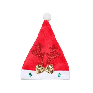 Detail of red plush Santa hat with reindeer antlers and golden bow decoration