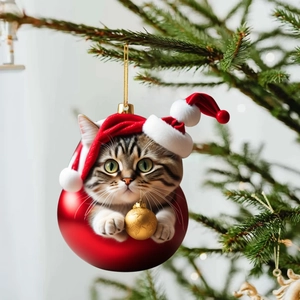 Detail of cute tabby cat in Santa hat holding golden ball on acrylic Christmas tree ornament