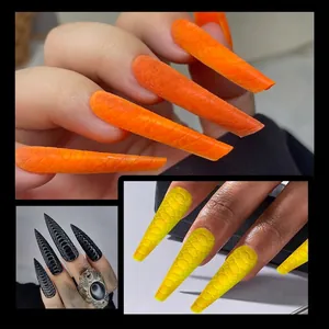 Long stiletto press-on nails featuring textured 3D snake pattern in orange and black