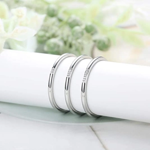 Minimalist silver micro-set zircon rings with thin bands on white display stand