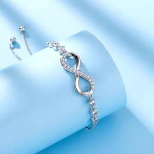Detailed view of silver infinity bracelet with pavé cubic zirconia and adjustable slider clasp