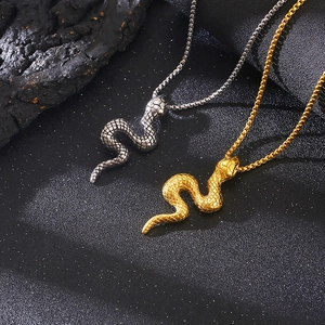 Macro shot of 3D snake pendants in gold and silver finish with detailed scale texture