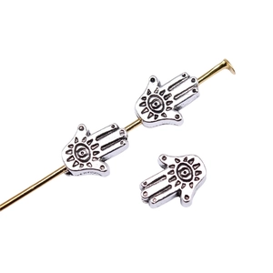 Ancient gold Hamsa hand charms for jewelry making with evil eye detail on white background