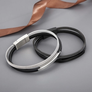 Close-up of leather bracelets with steel mesh overlay and secure magnetic clasps