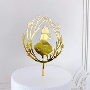 Detailed view of a golden acrylic Happy Birthday cake topper with an Alice silhouette