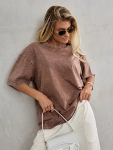 Detail of vintage washed terracotta cotton t-shirt featuring distressed knit texture