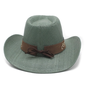 Detail of western cowboy straw hat with brown suede band and floral embroidery pattern