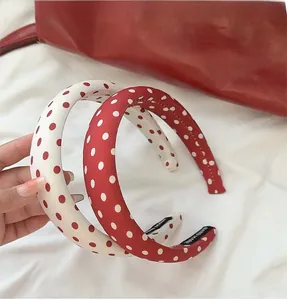 Close-up of red and white polka dot sponge headbands with handmade interior labels