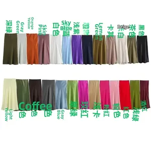 Flat lay display of satin midi skirts in 26 vibrant colors with silky texture