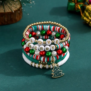 Macro detail of Christmas beaded bracelets with Santa charms and festive letter beads