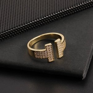 Detailed close-up of 18K gold T-shaped open ring with cubic zirconia micro-paving