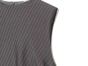 Detail of dark grey pinstripe fabric with invisible zipper and padded shoulder design