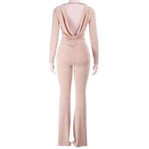 Detailed back view of backless slim fit velvet jumpsuit in apricot with flared pants