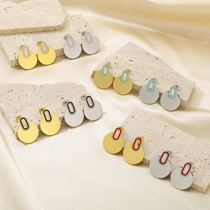 Detailed close-up of multicolor enamel disc earrings in gold and silver finish