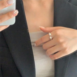 Elegant 925 sterling silver open ring featuring a single white pearl on a model's finger