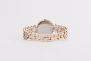 Detail of rose gold quartz watch band with sparkling crystals and fold-over clasp closure