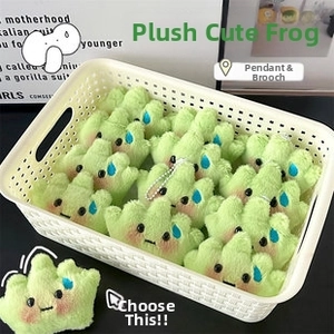 Macro shot of cute plush green grass doll pendants and brooches in a white storage basket