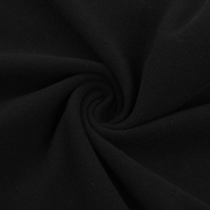 Close-up of black knitted fabric showing soft texture and premium draping quality