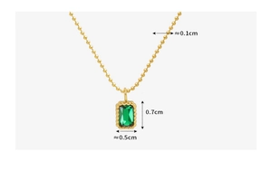 Detailed view of emerald zircon necklace with measurements of pendant and golden chain