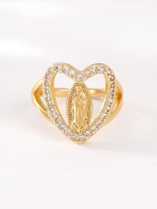 Detailed macro view of gold heart ring with Mary relief and white zircon stones
