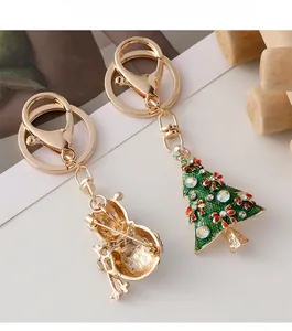 Detail of green Christmas tree keychain with colorful rhinestones and gold alloy finish