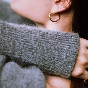 Minimalist gold knotted hoop earrings for women featuring elegant twisted metal design