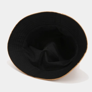 Retro corduroy bucket hat in black with brown woven brim trim, shown from top-down view