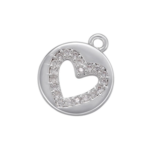 Macro detail of a silver round pendant with a hollow heart and micro-pave zircons