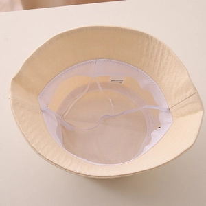 Detail of cotton sun hat interior with adjustable drawstring and 100% cotton label